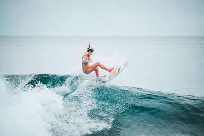 Surfer riding the Lohis surf break at Adaaran Select Hudhuran Fushi