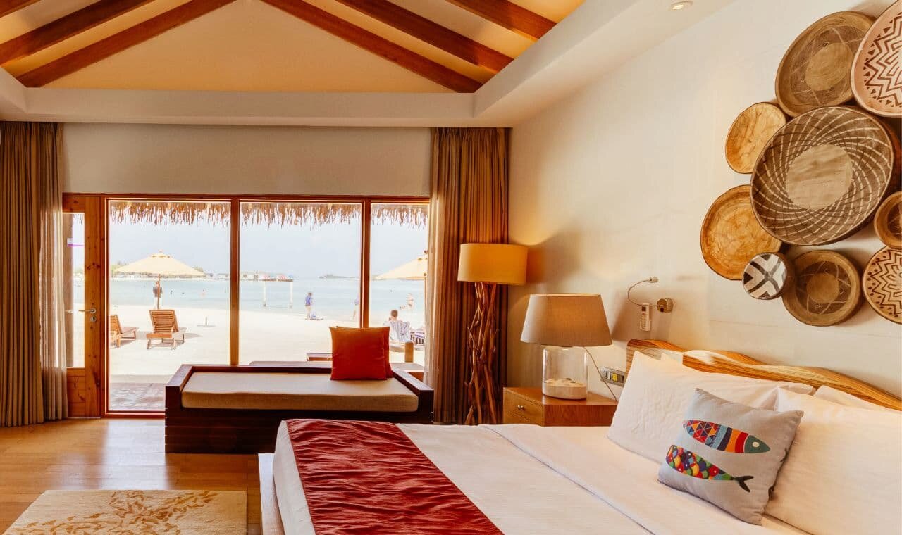 Beach Bungalow and its sun loungers on the sand at Cinnamon Dhonveli