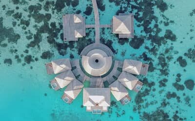 Coco Spa overwater treatment pavilions above the lagoon at Coco Bodu Hithi
