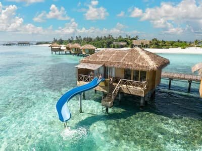 Lagoon Suite with Slide at Cocoon Maldives, slide running from the deck into the lagoon